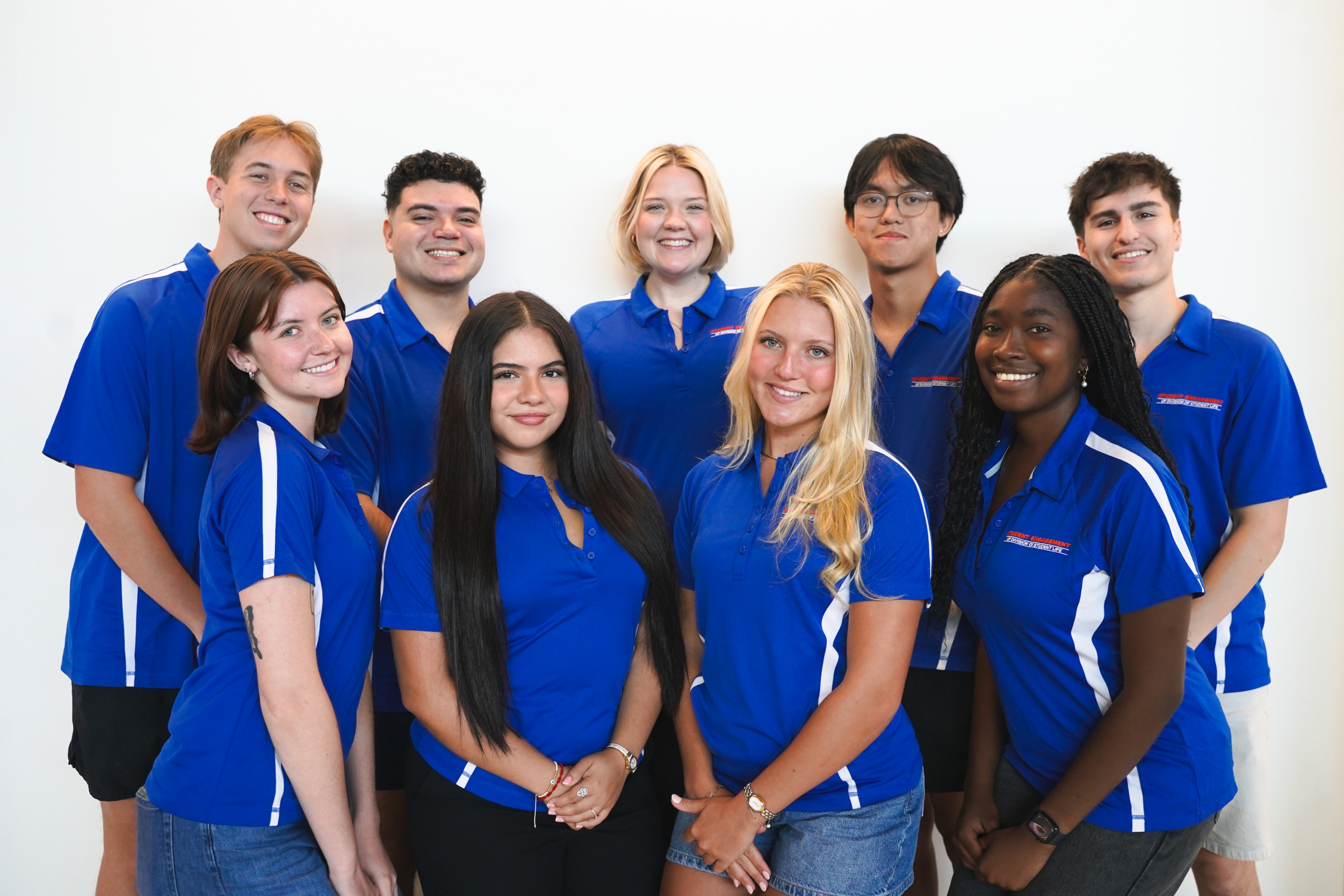 Student Engagement Ambassadors wearing their polos and smiling for the camera.
