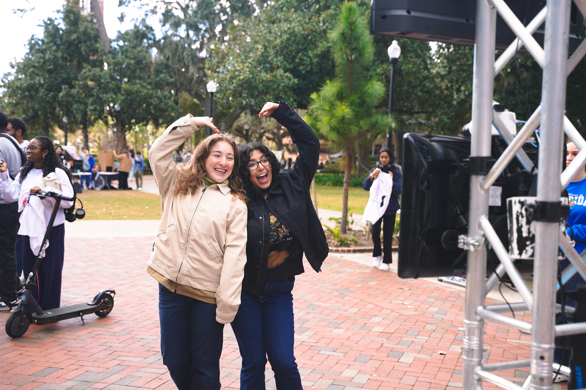 Two students posing in front of the Photo Booth at the Plaza of the Americas. At the UNITY Celebration event.